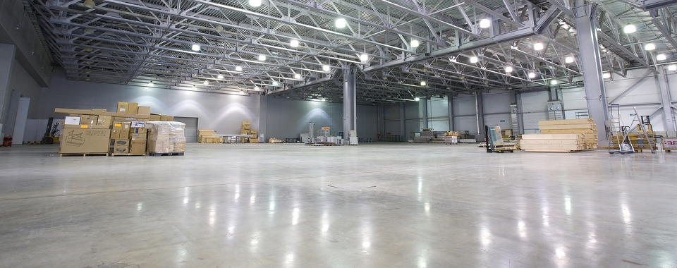 Large warehouse facility with wood pallets stacked with boxes