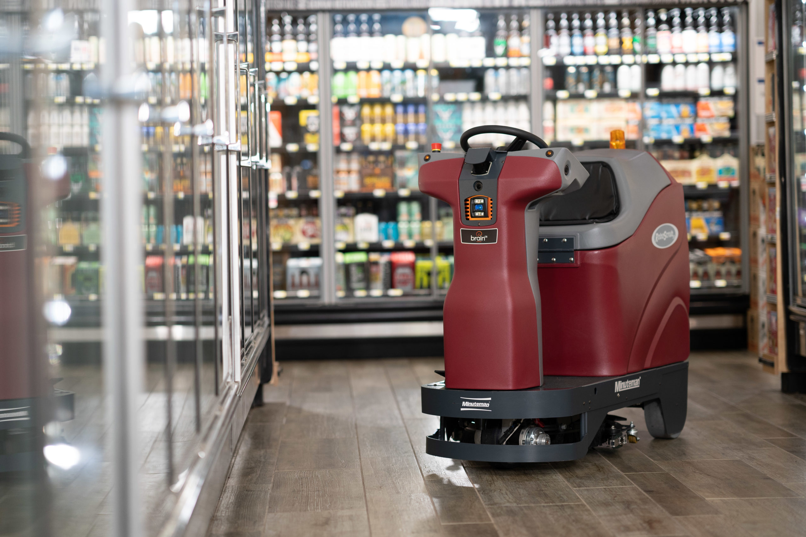 RoboScrub 20 robotic floor scrubber in a grocery store aisle